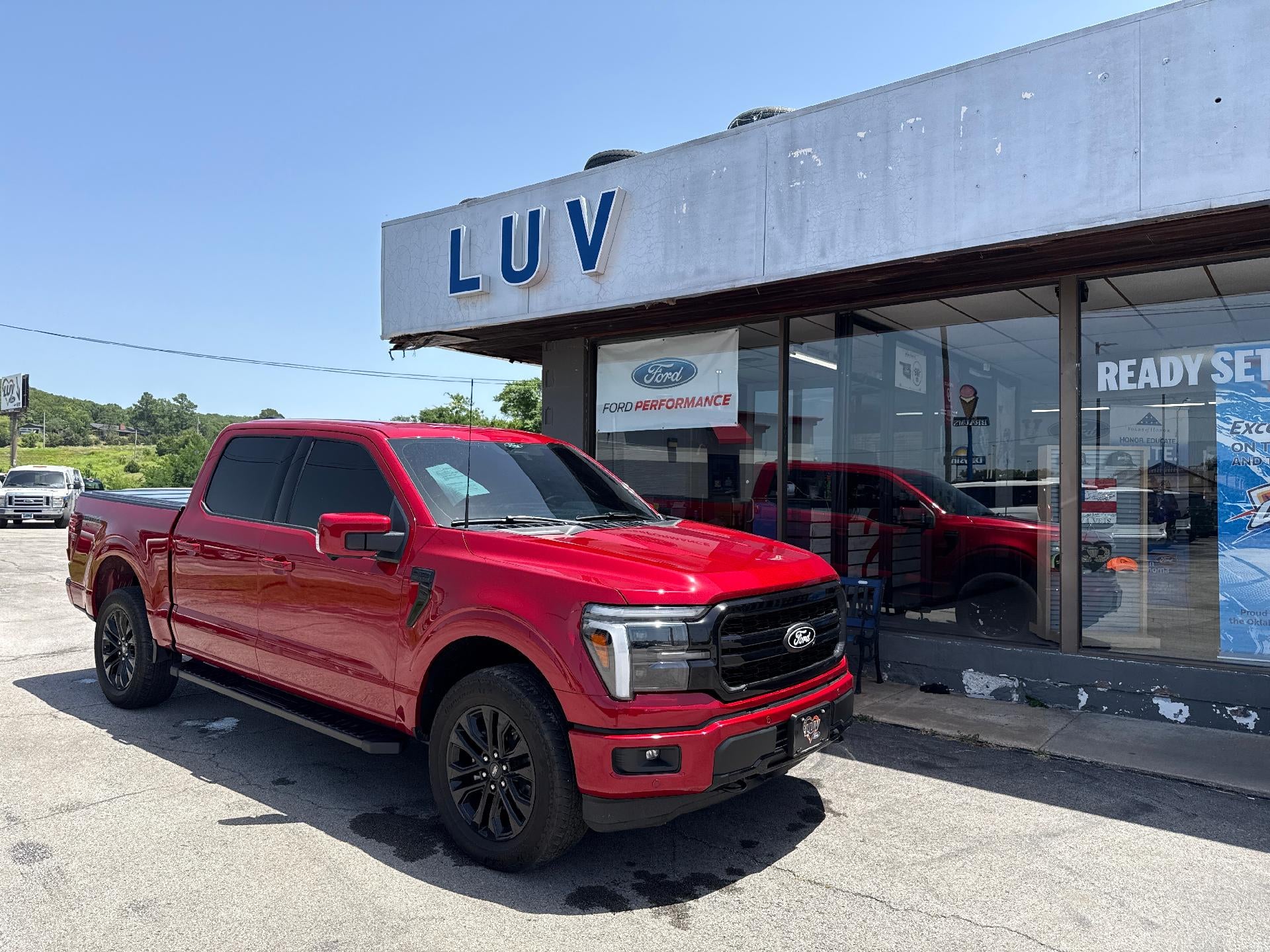 2025 Ford F-150 LARIAT 4WD SuperCrew 5.5' Box in Rapid Red Metallic Tinted Clearcoat — front three-quarter view